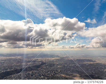Wide-angle shot captures city horizon under dynamic cloud formations 137374226