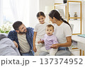 Happy family at home with parents, daughter and baby sharing joyful moments 137374952