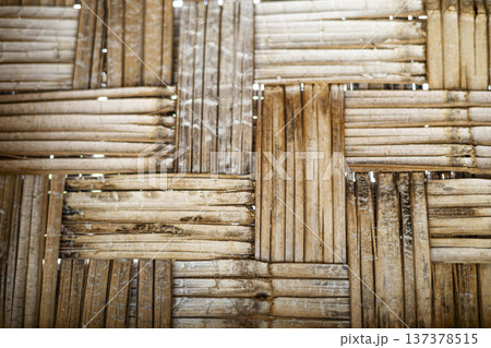 Interlocking Natural Bamboo Texture Traditional, Detailed shot of traditional interlocking bamboo weave revealing rich organic texture and craftsmanship, suitable for editorial and design use. Interlocking Natural Bamboo Texture Traditional, Detailed shot of traditional interlocking bamboo weave revealing rich organic texture and craftsmanship, suitable for editorial and design use. 137378515