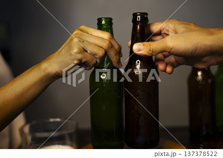 Celebration Toast With Cold Beer, Chilled beer glasses raised in a cheerful toast, with condensation and golden tones evoking refreshment and shared moments of joy. 137378522
