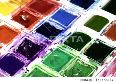 A Colourful Watercolour Painters Pallet of Messy Used Half Pan Paints Creative Background A Colourful Watercolour Painters Pallet of Messy Used Half Pan Paints Creative Background 137378813