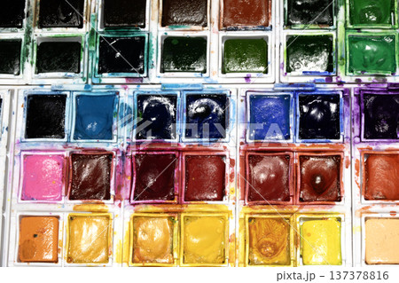 A Colourful Watercolour Painters Pallet of Messy Used Half Pan Paints Creative Background A Colourful Watercolour Painters Pallet of Messy Used Half Pan Paints Creative Background 137378816