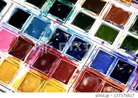 A Colourful Watercolour Painters Pallet of Messy Used Half Pan Paints Creative Background 137378817