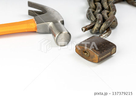 Close up of hammer and unlocked padlock isolated on white background Close up of hammer and unlocked padlock isolated on white background 137379215