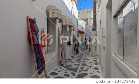 Cobblestone narrow shopping street surrounded by white buildings 137379438