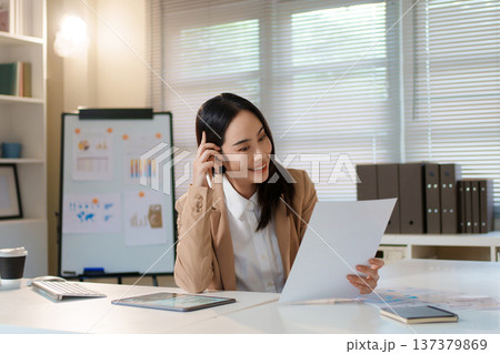 Professional businesswoman reviewing financial document and analyzing report data. 137379869