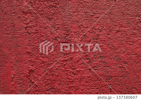 Wall of concrete piles is painted with red paint. Wall of concrete piles is painted with red paint. 137380607