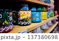Colorful Hand Painted Ceramic Cups on Wooden Shelf 137380698