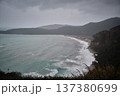 Dramatic Coastal Bay with Waves and Mountainous Shoreline 137380699