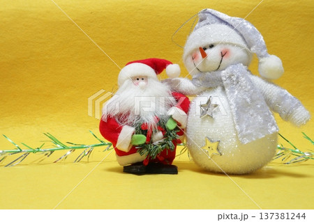 The snowman hugs Santa Claus. 137381244