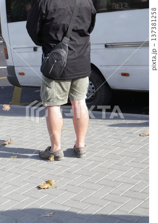 A photo of feet on the sidewalk. A photo of feet on the sidewalk. 137381258