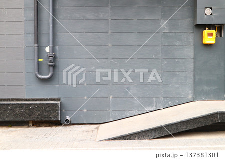 The pipe with a valve on the outside wall. The pipe with a valve on the outside wall. 137381301