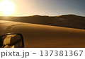 Driving Through Desert Sand Dunes at Sunset 137381367