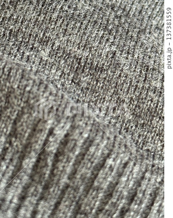 Close-up texture of gray knitted fabric showing detailed patterns, ideal for textile background 137381559