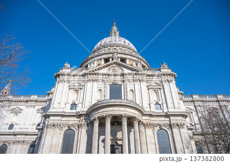 St Pauls Cathedral is shown from below against a clear blue sky in London. The structure features a large dome and detailed architecture. Visitors can enjoy the view during the day. St Pauls Cathedral is shown from below against a clear blue sky in London. The structure features a large dome and detailed architecture. Visitors can enjoy the view during the day. 137382800