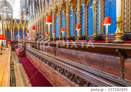 Visitors look at the Quire within Westminster Abbey in London. The area features choir stalls and decorative elements. Many come to admire the architecture and the rich history. Visitors look at the Quire within Westminster Abbey in London. The area features choir stalls and decorative elements. Many come to admire the architecture and the rich history. 137382805