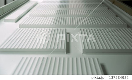 White architectural detail with grooved texture and repeating lines. Minimalist abstract background concept. White architectural detail with grooved texture and repeating lines. Minimalist abstract background concept. 137384922