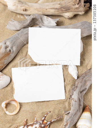 Mockup of blank cards on beige sand with seashells, template for beach wedding and event graphics Mockup of blank cards on beige sand with seashells, template for beach wedding and event graphics 137385108