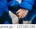 Close-up of two children's hands holding each other on the street. Frendship 137385186