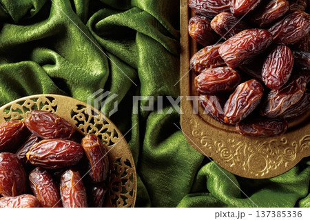 Dates on a golden platter. 137385336