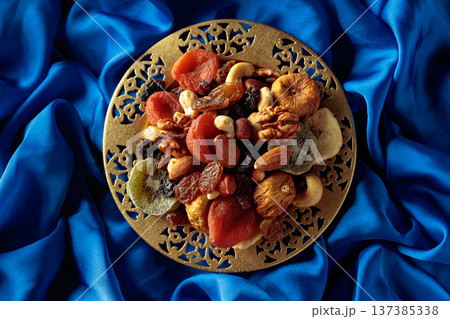 Assortment of dried tropical fruits, nuts and raisins. Assortment of dried tropical fruits, nuts and raisins. 137385338