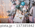 Christmas and New Year background. Christmas tree decorated with toys and gifts. Lantern candlestick 137385842