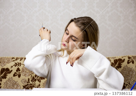 Female artist got paint on her sweater while painting. Stained clothes due to careless painting. The problem with paint leaving marks on clothing. The painter ruined her clothes with paint Female artist got paint on her sweater while painting. Stained clothes due to careless painting. The problem with paint leaving marks on clothing. The painter ruined her clothes with paint 137386112