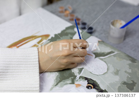 Finished image for painting project. Close up of hand applying paint to canvas. Final photograph for creative and artistic theme. Concept art for the painting and drawing Finished image for painting project. Close up of hand applying paint to canvas. Final photograph for creative and artistic theme. Concept art for the painting and drawing 137386137