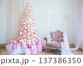 Christmas tree made of pink and white balloons and pink armchair in the interior of the room 137386350