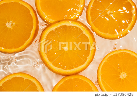 Top view of orange slices in splashing water. Top view of orange slices in splashing water. 137386429