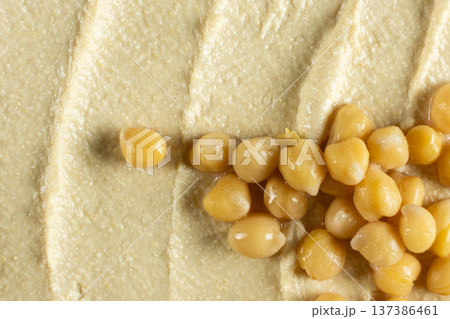 Boiled chickpeas on top of hummus texture macro Boiled chickpeas on top of hummus texture macro 137386461