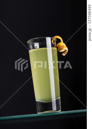 Limoncello Shot with Citrus Twist on Dark Background.  Elegant Aperitif Composition 137386495