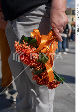 Close-up of an orange bouquet on the an annual festival of Portuguese universities. Close-up of an orange bouquet on the an annual festival of Portuguese universities. 137386620