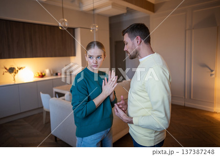 Cheating husband creating lies on go while busted by wife about love affair, couple in serious talk. Cheating husband creating lies on go while busted by wife about love affair, couple in serious talk. 137387248
