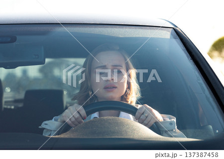 Woman drives car for the first time. Inexperienced driver in stress and confusion after an accident 137387458