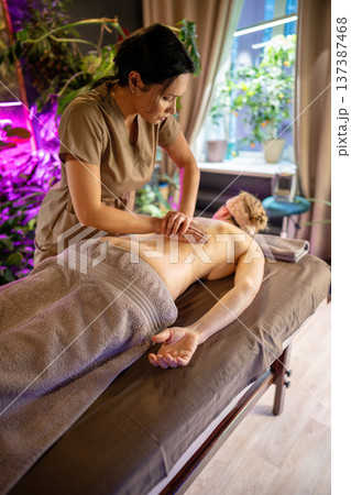 Woman relaxing on spa bed in beauty clinic, full body treatment therapy for healthcare and wellness. Woman relaxing on spa bed in beauty clinic, full body treatment therapy for healthcare and wellness. 137387468