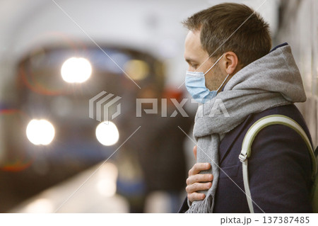 man wearing protective mask against protection flu in public transport, subway 137387485