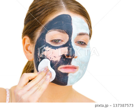 Girl remove black white mud mask from face 137387573