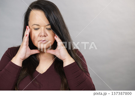 Worried woman having painfull headache Worried woman having painfull headache 137387800