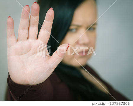 Woman showing stop hand sign gesture. 137387801