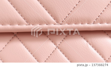 The surface texture of the artificial leather is pink, stitched in the form of diamonds, squares, rectangles. Quilted eco-leather.  137388274