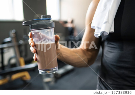 Protein shake after workout in gym hand holding shaker fitness nutrition 137388936