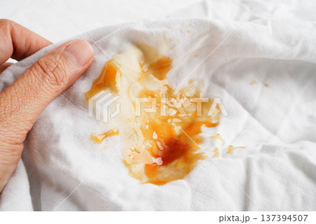 Dirty tomato sauce stain or ketchup on cloth to wash with washing powder, cleaning housework. Dirty tomato sauce stain or ketchup on cloth to wash with washing powder, cleaning housework. 137394507