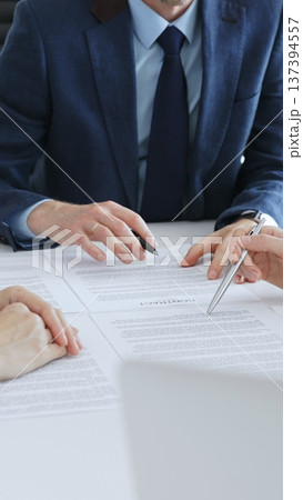 Business people or lawyers reviewing contract documents during an office meeting, discussing terms, and preparing for agreement signing, focusing on legal consultation. Teamwork concept Business people or lawyers reviewing contract documents during an office meeting, discussing terms, and preparing for agreement signing, focusing on legal consultation. Teamwork concept 137394557