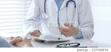 Female doctor explaining diagnosis to her patient during medical consultation in medical office, healthcare and medical concept. Medicine and healthcare concept Female doctor explaining diagnosis to her patient during medical consultation in medical office, healthcare and medical concept. Medicine and healthcare concept 137394674