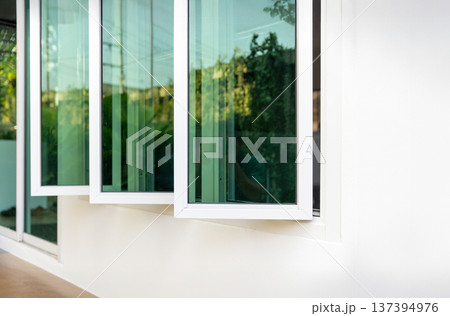 Three panel aluminium casement window stay on white wall. 137394976