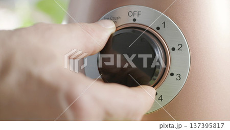 Person adjusts setting on a device at home 137395817