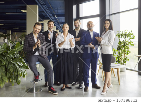 Happy business team clapping hands, smiling on meeting in open space office Happy business team clapping hands, smiling on meeting in open space office 137396512