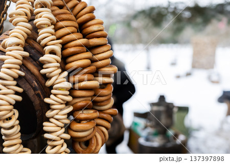 Charming winter marketplace with toasted bagels on aged wooden spools and retro collectibles Charming winter marketplace with toasted bagels on aged wooden spools and retro collectibles 137397898