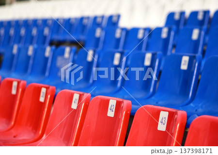 Empty seats in a stadium, close-up. Blue and red seats            137398171